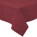 A burgundy tablecloth with a white border on a table.
