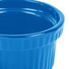 A close up of a Tablecraft sky blue cast aluminum souffle bowl with ridges.