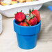 A Sky Blue Tablecraft condiment bowl filled with strawberries.