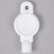 A white plastic key for a Lavex circular toilet tissue dispenser.