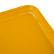 A close up of a rectangular mustard yellow Cambro tray.