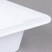 A white Carlisle food pan with a lid.