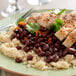 A close-up of a plate of rice and Furmano's seasoned black beans with chicken.