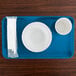 A blue Cambro rectangular tray with a bowl and a cup on it.