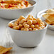 A bowl of Furmano's organic chickpeas with chips on a table.