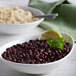 A bowl of Furmano's Organic Black Beans with rice and a spoon.