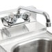 A close up of a Regency wall mount bar sink faucet.