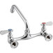 A chrome Regency wall mount faucet with two handles and an 8" swing spout.