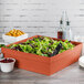A Tablecraft copper square bowl filled with salad on a table in a salad bar.