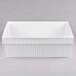 A white rectangular cast aluminum bowl with a ribbed edge.