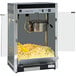 A Paragon Contempo Pop popcorn machine with a yellow scoop in a pile of popcorn.