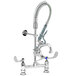 A T&S chrome deck mounted pre-rinse faucet with hose and sprayer.