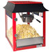 A red and black Paragon 1911 Original popcorn machine with a lid.