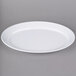 A white Carlisle rimmed oval platter on a gray surface.