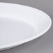 A white Carlisle rimmed oval platter on a white surface.