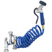 A blue coiled hose attached to a T&S pet grooming faucet.