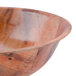 A close up of a Thunder Group woven wood salad bowl on a table.