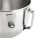 A stainless steel KitchenAid mixing bowl with a handle.