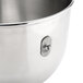 A close up of a stainless steel KitchenAid mixing bowl with a handle.