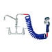 A T&S wall mount pet grooming faucet with a blue hose and blue handle.