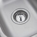 A close-up of a stainless steel Eagle Group drop-in sink with a drain.