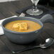 A Tablecraft granite cast aluminum soup bowl with croutons on top.