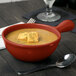 A Tablecraft copper cast aluminum soup bowl with a handle filled with soup and topped with croutons.