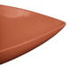 A Tablecraft copper triangle display bowl with a curved edge.