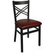 A black metal BFM Seating chair with a burgundy vinyl seat.