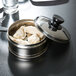 A Town stainless steel dim sum steamer cover on a pot of dumplings.
