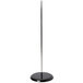 A black base with a silver pole on a stand.