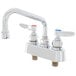 A chrome T&S deck-mounted workboard faucet with two handles and a swing nozzle.