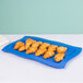 A Tablecraft blue speckled rectangular platter with croissants on it.