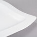 A white rectangular Tablecraft cast aluminum platter with a curved edge.