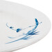 A close up of a Thunder Group Blue Bamboo melamine plate with blue designs.