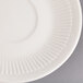 A close-up of a 5 3/8" ivory (American white) china saucer with an embossed rim.