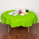 A table with a Fresh Lime Green OctyRound table cover, plates, and cups.