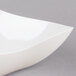 A Fineline ivory plastic serving bowl with a wavy edge.
