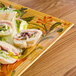 A GET Venetian tray with sandwiches on it.