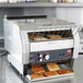 A Hatco commercial toaster with slices of toast on a tray.