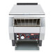 A stainless steel Hatco conveyor toaster with a shelf on top.