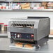 A Hatco TQ-1800 conveyor toaster with toasts on the rack.
