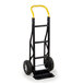 A black hand truck with yellow continuous handles.