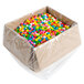 A plastic container filled with colorful Dutch Treat Bubble Gum Bits candy.