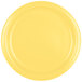 A close-up of a Creative Converting Mimosa Yellow paper plate.
