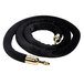 A black rope with brass ends for crowd control stanchions.