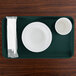 A teal Cambro rectangular tray with a white plate, white bowl, and white cup on it.