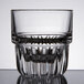 A close up of a clear Libbey Everest stackable juice glass with a pattern.