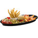 A Tablecraft black cast aluminum tray with food on it.