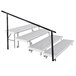 National Public Seating side guardrail for 4-level stage risers with black railing.